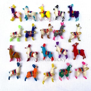 May include: A collection of twenty small, handcrafted llama-shaped pins made from colorful yarn. Each pin features a unique color combination, including shades of red, blue, yellow, green, white, and purple, with a small metal safety pin attached.