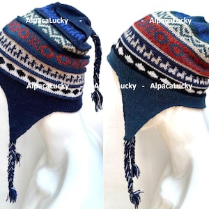 May include: Two blue and white patterned knit hats with long tassels. The hats have a geometric design with red, white, and blue accents.