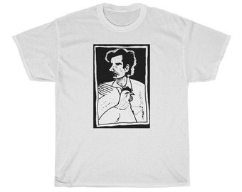 May include: A white t-shirt with a black and white illustration of a man holding a chicken. The illustration is framed in a black rectangle.