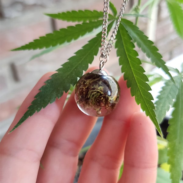CBD flower bud encapsulated in epoxy resin, in the shape of a sphere
