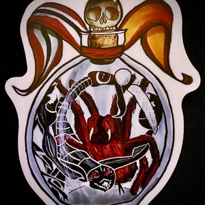 May include: A glass bottle with a skull stopper and a red and orange ribbon. Inside the bottle are two spiders, one black and one red.