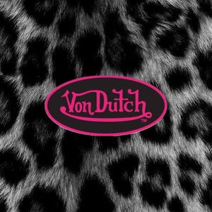 May include: A black and white leopard print pattern featuring a central horizontal oval emblem with a black background and a bright pink border. The text Von Dutch is written in a stylized pink script font inside the oval, followed by a small TM symbol.