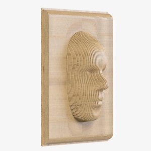 May include: Wooden wall art depicting a human face profile. The face is made from layered, light-coloured wood, giving a 3D effect. The artwork is mounted on a rectangular wooden frame with rounded corners. The measurements are in centimetres.