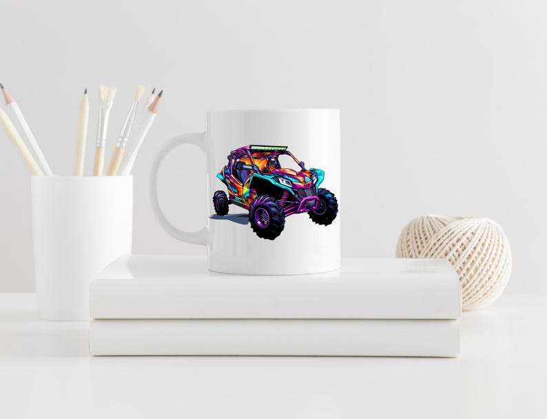 May include: White ceramic mug with a colorful illustration of a pink, blue, and green off-road vehicle with a light bar on the roof.