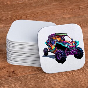 May include: A stack of white coasters with a colorful graphic of an off-road vehicle on the top coaster. The vehicle is painted in shades of orange, purple, blue, and green.