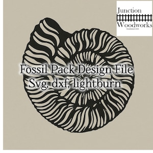 May include: Black and white illustration of a fossilized ammonite shell. The image includes the text "Fossil Pack Design File Svg, dxf, lightburn" and a logo for Junction Woodworks.