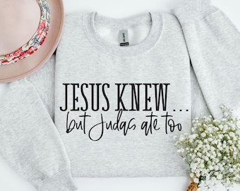 May include: A gray sweatshirt with the text "JESUS KNEW... but Judas ate too" printed in black.