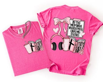 May include: Two bright pink t-shirts. One shirt has a graphic of a book, a drink, and a cross. The other shirt has a bow, headphones, a drink, a book, and the text "In the morning when I rise, give me Jesus."