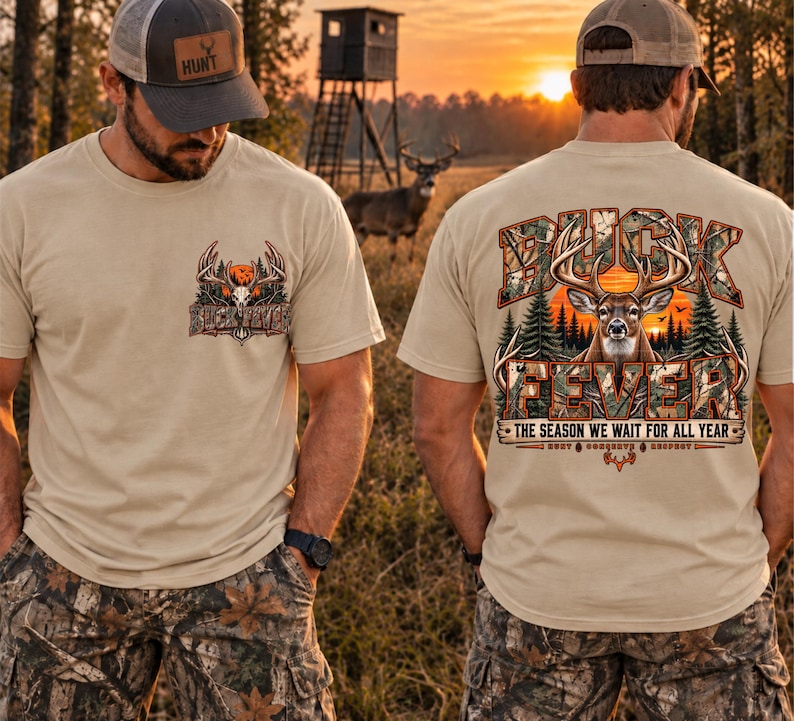 May include: A beige t-shirt featuring a small graphic on the front left chest and a large graphic on the back. Both graphics depict a deer head, pine trees, and a sunset with the text BUCK FEVER. The back includes the text THE SEASON WE WAIT FOR ALL YEAR.