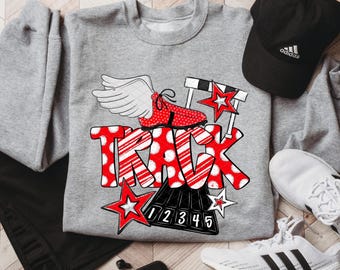 May include: A gray sweatshirt with a red and white graphic that says "TRACK". The graphic includes a running shoe with wings, stars, and a hurdle. A black Adidas cap and white sneakers are also in the image.