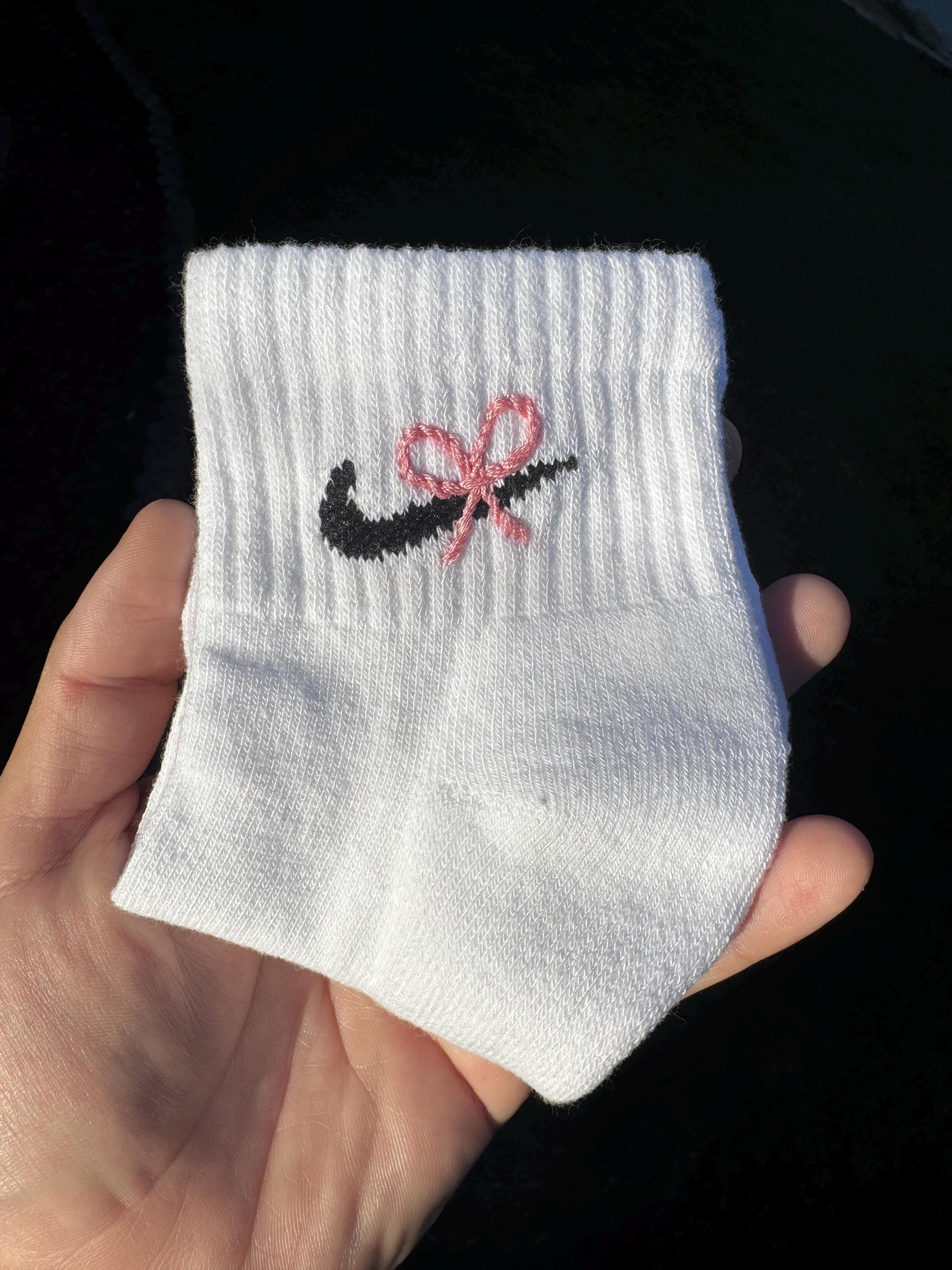 white nike socks with pink logo