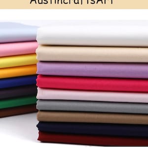 May include: A selection of folded fabric in a range of colours, such as white, pink, yellow, and brown. The fabric is stacked neatly, displaying a variety of hues and textures. The text "AustincraftsArt" is visible at the top.