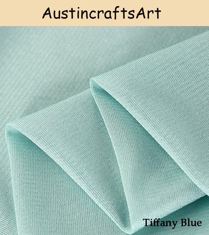 Może przedstawiać: Kawałek materiału w jednolitym kolorze Tiffany blue o drobno prążkowanej strukturze dzianiny. Materiał jest złożony, tworząc miękkie, warstwowe fałdy. Tekst AustincraftsArt jest widoczny u g&oacute;ry, a tekst Tiffany Blue znajduje się na dole.