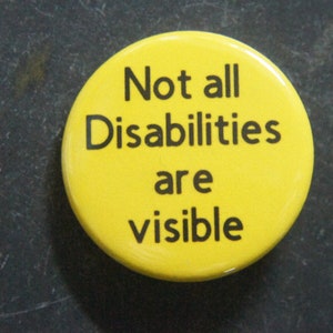 May include: A yellow button with the text "Not all Disabilities are visible" in black. The button is circular and set against a dark, textured background.
