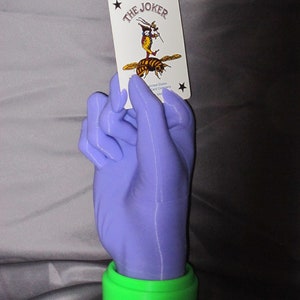 Hand Holiding a Joker Card