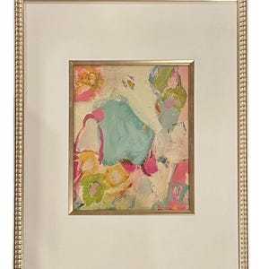 May include: A framed abstract painting with a white background and colorful paint strokes in shades of pink, blue, green, and yellow.
