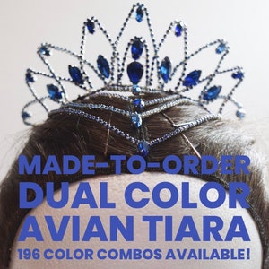 May include: A silver and blue tiara with a crown-like design. The tiara is decorated with blue rhinestones and is made to order. The text "MADE-TO-ORDER DUAL COLOR AVIAN TIARA 196 COLOR COMBOS AVAILABLE!" is displayed below the tiara.