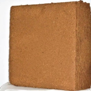 May include: A brown rectangular block of compressed coconut coir, a natural growing medium for plants.