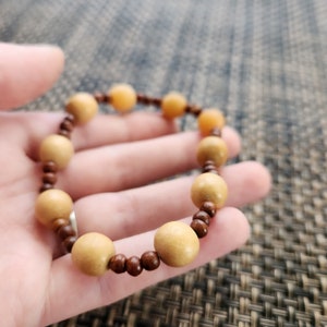 Wood or Woodn&#39;t You - Wooden Beads In Large and Small Sizes Strung Together