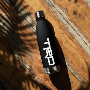 May include: Black water bottle with a silver lid and the word "TRD" printed in white on the side.