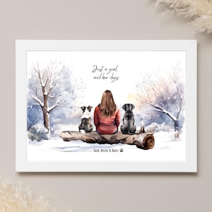 May include: A watercolour painting of a woman sitting on a log with two dogs. The woman is wearing a red jacket and the dogs are black and white. The background is a snowy woodland scene. The text "Just a girl and her dogs" is written above the woman and dogs. The text "Sash Helen & Daisy" is written below the log.