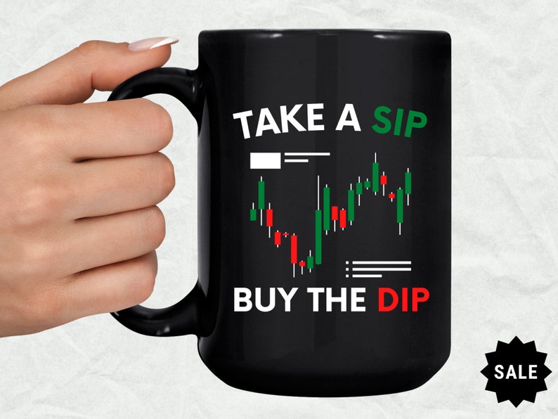 May include: Black coffee mug with a white graphic of a stock market chart and the text "Take a Sip Buy the Dip".