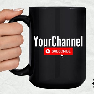 May include: Black coffee mug with white text that says "YourChannel" and a red button that says "SUBSCRIBE".