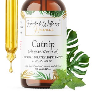 May include: A brown glass bottle of Herbal Wellness Hawaii Catnip supplement. The label includes the text "Catnip (Nepeta Cataria)" and "4 fl oz (120ml)". A dropper with a golden liquid is on the left. Green leaves and foliage are in the background.