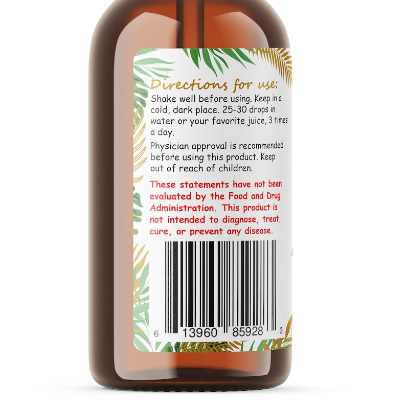 Op de afbeelding: Een bruine glazen fles met een etiket met gebruiksaanwijzingen en een barcode. Het etiket heeft een decoratieve rand met groene en gouden bladeren. De fles bevat een vloeistof.