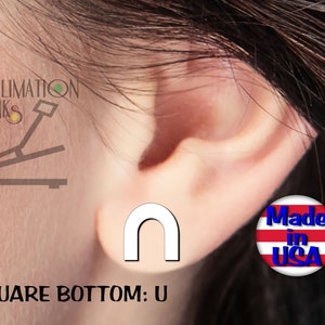 May include: A white, square-bottomed U-shaped earring is shown on an ear. The earring is a simple, minimalist design. The image also includes the text "SQUARE BOTTOM: U" and a "Made in USA" sticker.