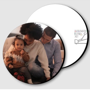 May include: Two white, circular sublimation blanks with black edges. One blank displays a family portrait of a mother, father, and child. The other blank has the text "SUBLIMATION BLANKS .NET" and a graphic.