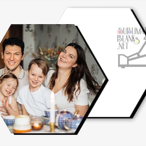 May include: A family of four smiling at a table with a lit candle and a blue and white teapot. The image is set within a white and black hexagon shape. The text "SUBLIMATION BLANKS .NET" is visible in the upper right corner.