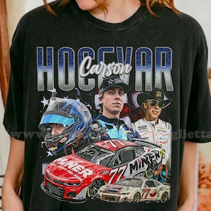 May include: Black t-shirt featuring a graphic design with the text "HOGEVAR Carson" above images of a race car driver, a race car, and the number 77. The design includes a blue and white color scheme.