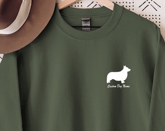 May include: A green sweatshirt with a white outline of a corgi dog and the text "Corgi Dog Mom" on the front.