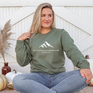 May include: A green sweatshirt with a white mountain graphic and the text "Faith can move mountains Matthew 17:20".