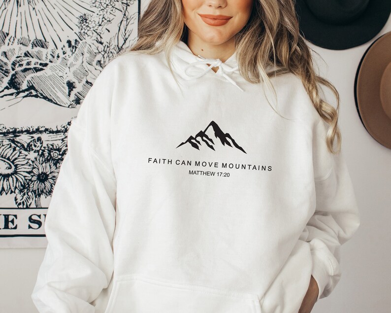 May include: White hoodie with a black mountain graphic and the text "Faith can move mountains Matthew 17:20".