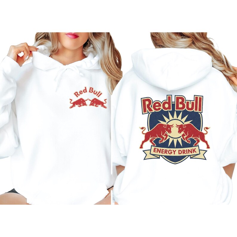 A woman wearing a white hoodie with the Red Bull logo and the Red Bull Energy Drink text on the back.