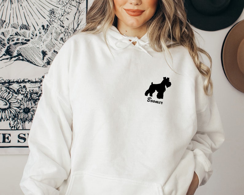 May include: White hoodie with a black silhouette of a Schnauzer dog and the text "Boomer" on the front.