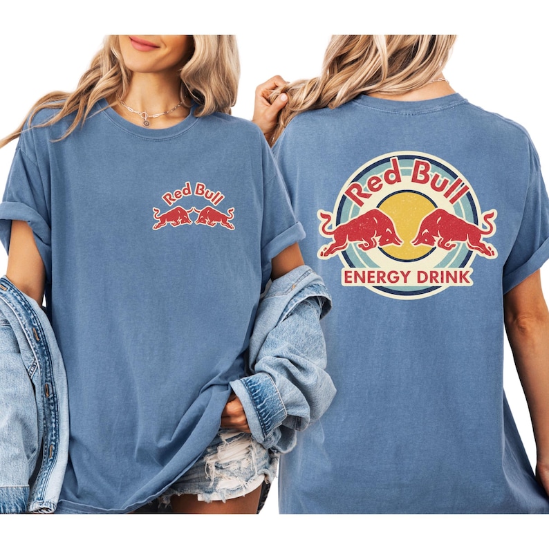 A woman wearing a blue t-shirt with the Red Bull logo and the text "Red Bull Energy Drink" printed on it.