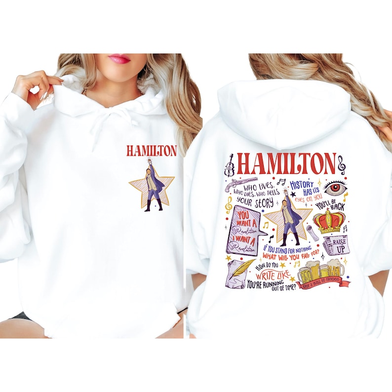 A white hoodie with a colorful graphic design featuring the character Hamilton from the musical Hamilton.