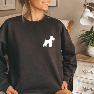 May include: Black sweatshirt with a white silhouette of a Schnauzer dog on the front.