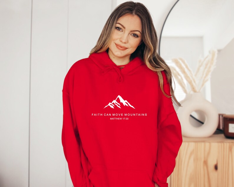 May include: Red hooded sweatshirt with a white mountain graphic and the text "FAITH CAN MOVE MOUNTAINS MATTHEW 17:20"