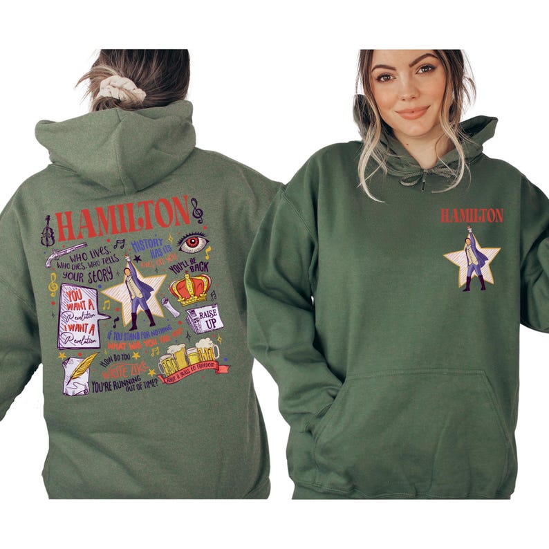 A woman wearing a green hoodie with various text and graphics printed on it, including a character from the musical Hamilton.