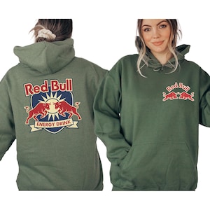 A woman wearing a green hoodie with the Red Bull logo and the text "Red Bull Energy Drink" printed on it.