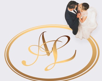 May include: A gold oval with a double outline and the letters "A" and "L" in a cursive font inside. A bride and groom are standing on the oval, looking at each other and smiling.