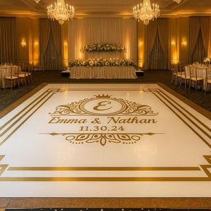May include: A ballroom decorated for a wedding, featuring a white dance floor with gold accents and the names "Emma & Nathan" and the date "11.30.24". The room has chandeliers, tables, and floral arrangements.