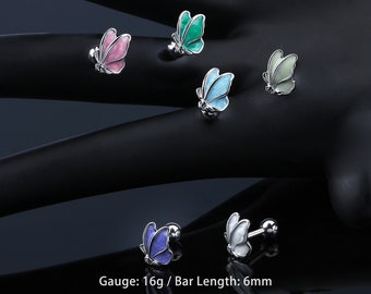 May include: Six butterfly-shaped body jewelry pieces in various colors, including pink, green, blue, light blue, and white. The jewelry is made of surgical steel and has a 16 gauge bar length of 6 mm.