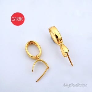 May include: Two gold-colored jewelry bails with oval loops and prong settings for pendants. A red circle in the upper left corner contains the text G18K, and the bottom right corner features the text AngelJeweBoutique.