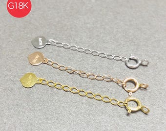 May include: Three gold, rose gold, and silver-colored necklace extenders. Each extender has a small tag with text and a chain that connects to a clasp. The image includes a red circle with the text "G18K".