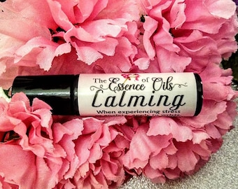 May include: A black roller bottle with a white label that reads "The Essence of Oils Calming When experiencing stress or anxiety apply to wrists."